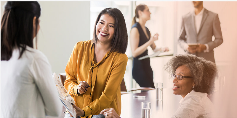 employees discuss benefits options during open enrollment season