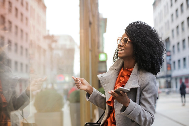 National PEO Week businesswoman smiling walking outside city