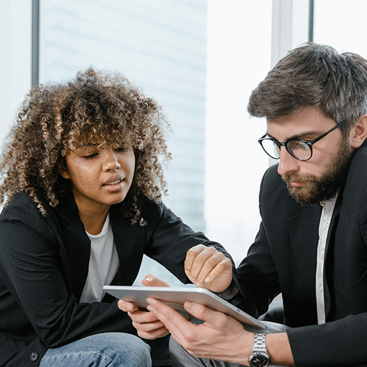 Woman and Man orking with a tablet