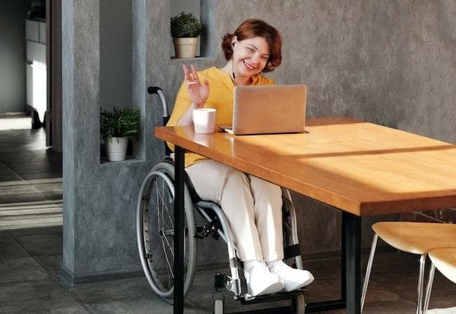 Women sit in a table with a laptop