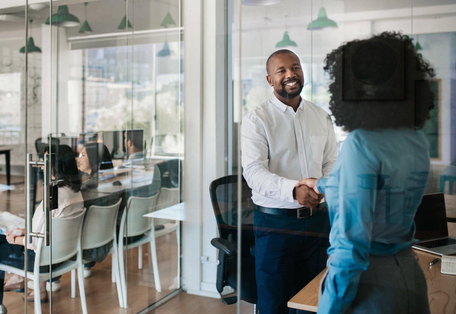 man shaking woman hand