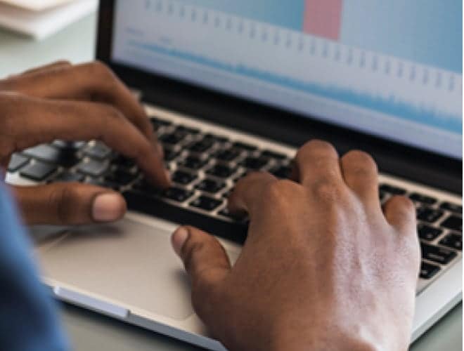 A man writting on a laptop