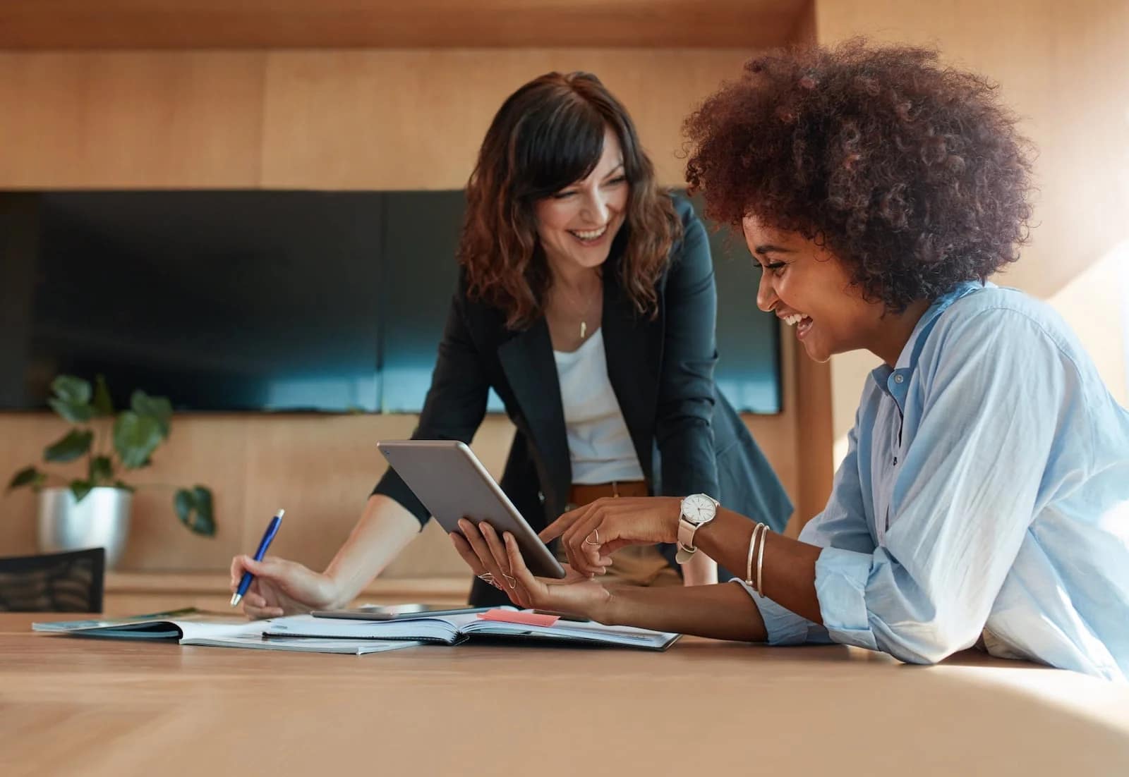 Two women working and laughing
