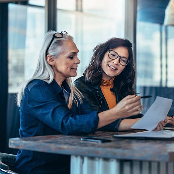 Two professional looking woman, working together in an office setting