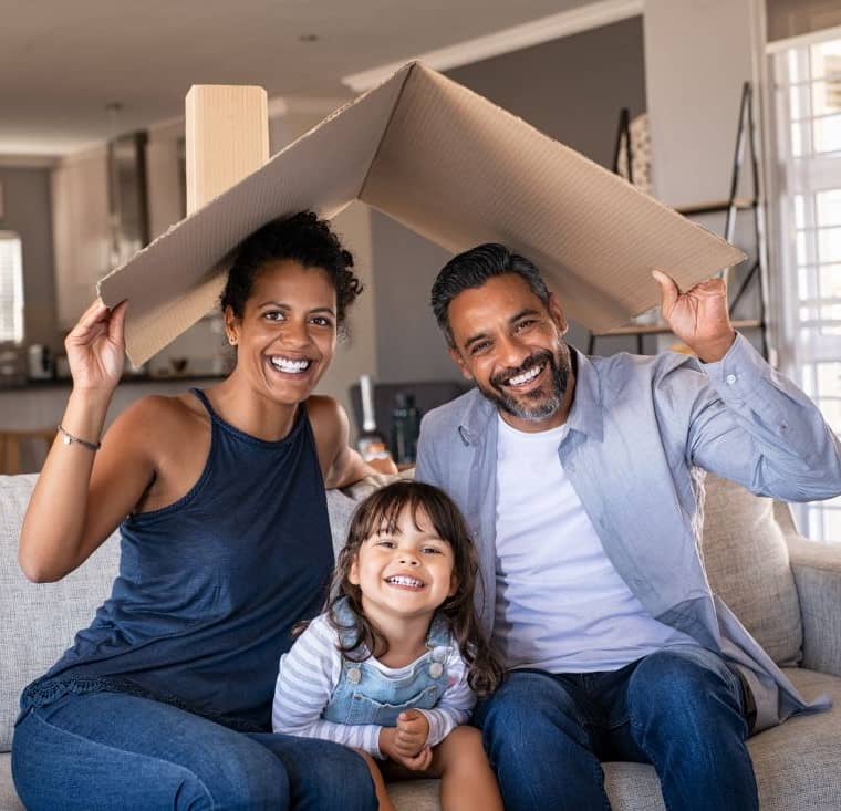 A family, playing with a cardboard box, mimicking a house roof